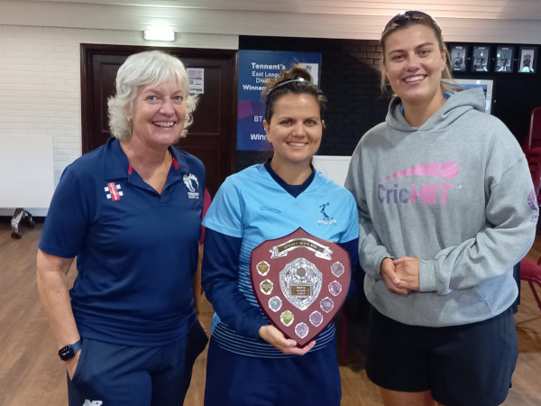 Annette Aitken-Drummond being presented with the WPL shield by Sue Strachan and Rosy Ryan